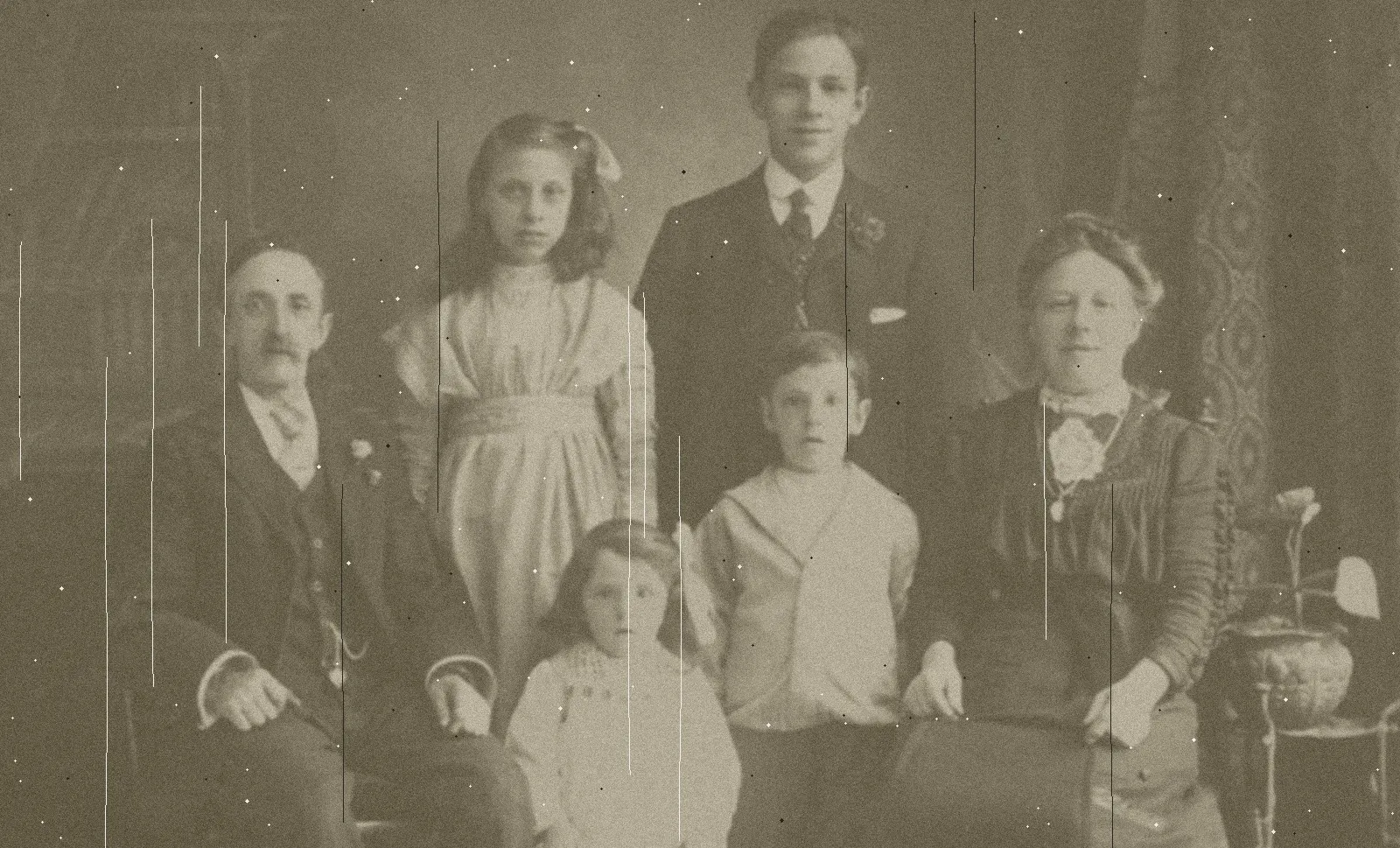 Before: A studio family portrait with scratches and fading, and the same portrait restored